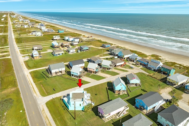 birds eye view of property featuring a water view and a view of the beach