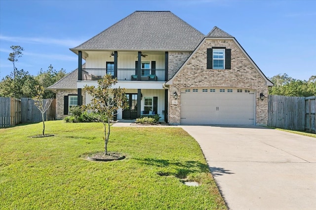 view of front facade featuring a balcony, a front lawn, and a garage