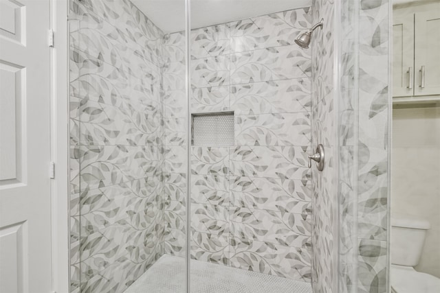 bathroom with toilet and an enclosed shower