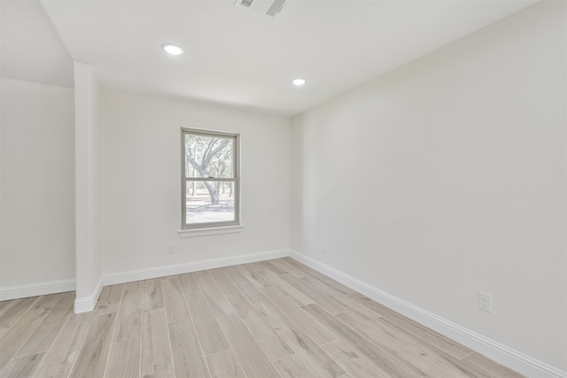 unfurnished room with light wood-type flooring