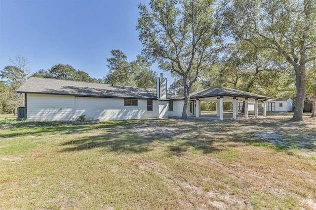 exterior space with a yard, a gazebo, central AC, and a storage unit