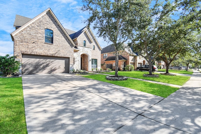 view of front of home featuring a front yard and a garage