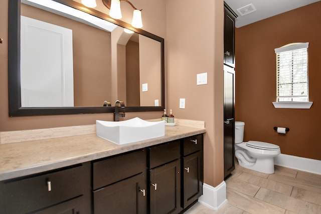 bathroom with toilet and vanity