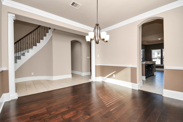 unfurnished dining area featuring crown molding, hardwood / wood-style flooring, and a chandelier