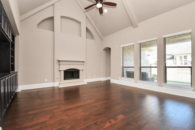 unfurnished living room with beam ceiling, dark wood-type flooring, high vaulted ceiling, and ceiling fan