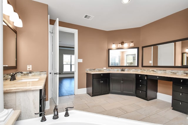 bathroom featuring vanity and decorative backsplash