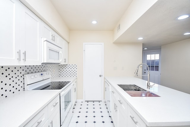 kitchen with white cabinetry, sink, and white appliances