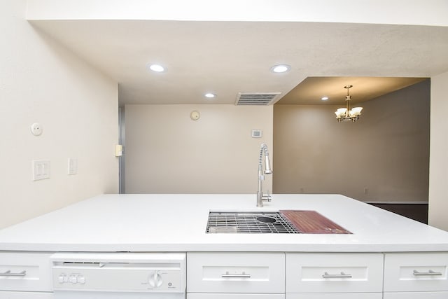 kitchen featuring white cabinetry, a chandelier, white dishwasher, pendant lighting, and sink