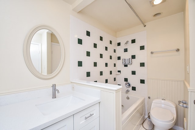 full bathroom with toilet, tiled shower / bath, and vanity