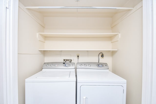 laundry room with washing machine and clothes dryer