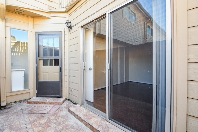 entrance to property featuring a patio area