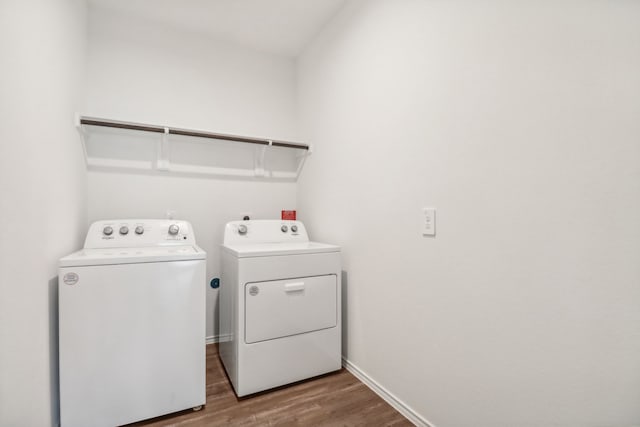 washroom with hardwood / wood-style floors and separate washer and dryer