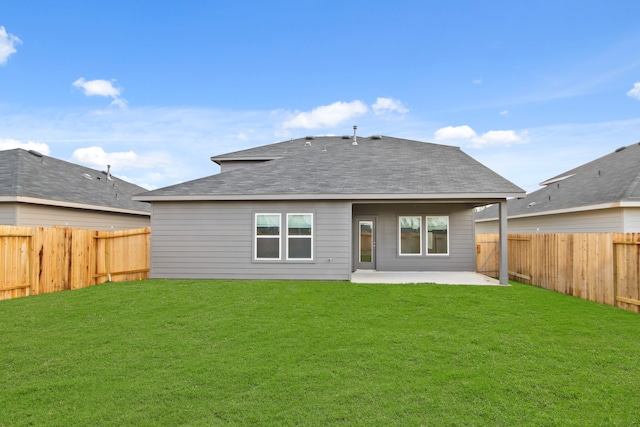 back of house with a yard and a patio