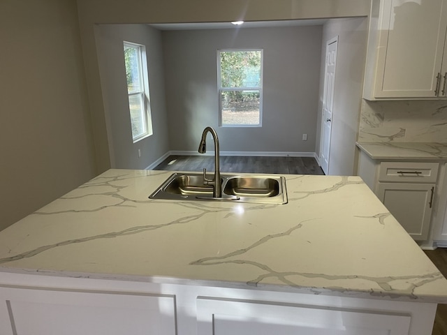 kitchen featuring white cabinets, tasteful backsplash, sink, and dark hardwood / wood-style flooring