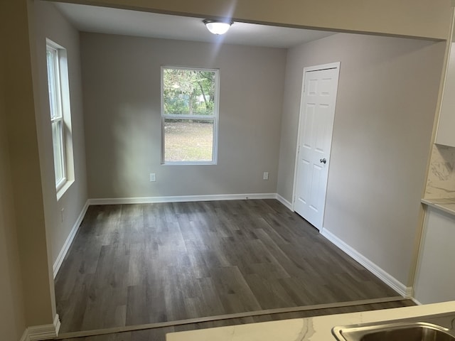 unfurnished room featuring dark hardwood / wood-style flooring