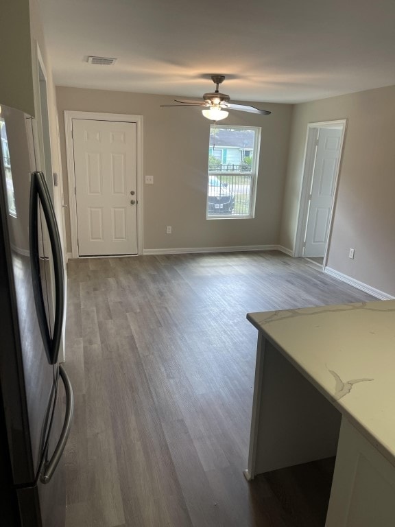 interior space with light hardwood / wood-style floors and ceiling fan