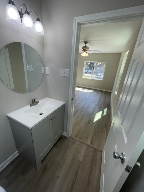 bathroom with vanity, hardwood / wood-style flooring, and ceiling fan