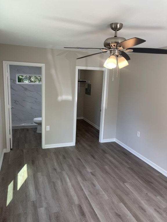 interior space featuring a closet, hardwood / wood-style flooring, ensuite bath, and ceiling fan