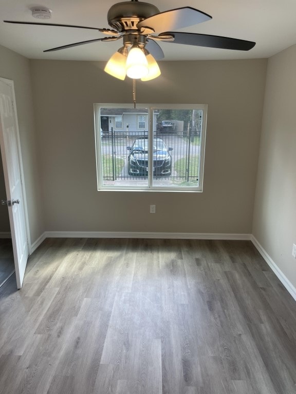 empty room featuring wood-type flooring and ceiling fan