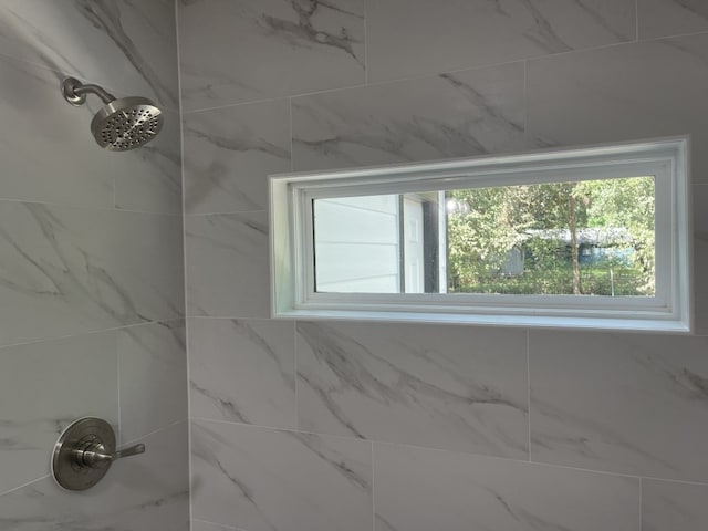 bathroom with tiled shower