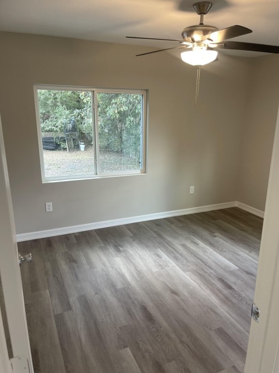 empty room with wood-type flooring and ceiling fan