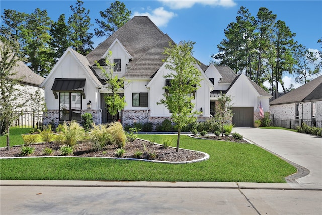 modern farmhouse featuring board and batten siding, brick siding, a standing seam roof, and fence