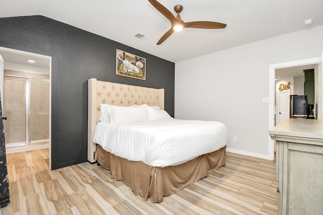 bedroom featuring light wood-type flooring, vaulted ceiling, and ceiling fan