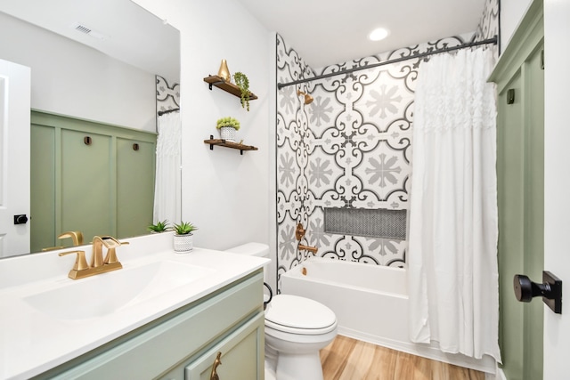 full bathroom with hardwood / wood-style flooring, vanity, toilet, and shower / tub combo