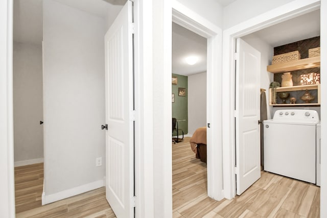 washroom with washer / clothes dryer and light wood-type flooring