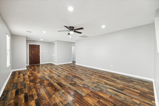 unfurnished room featuring dark wood-type flooring, a textured ceiling, and ceiling fan