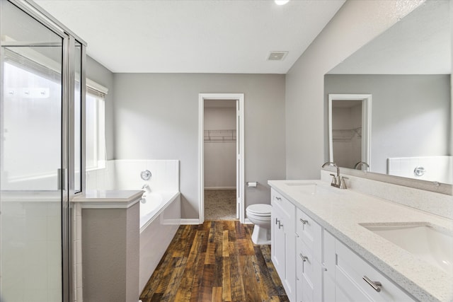 full bathroom with vanity, plus walk in shower, hardwood / wood-style flooring, and toilet