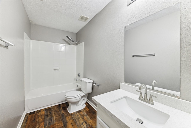 full bathroom with wood-type flooring, a textured ceiling, toilet, shower / bath combination, and vanity