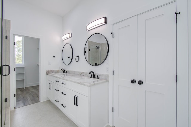 bathroom featuring vanity, tile patterned floors, and an enclosed shower