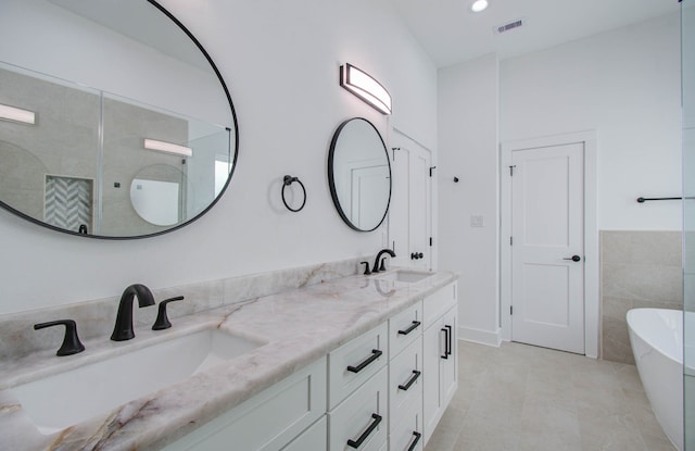 bathroom featuring tile walls, vanity, shower with separate bathtub, and tile patterned flooring