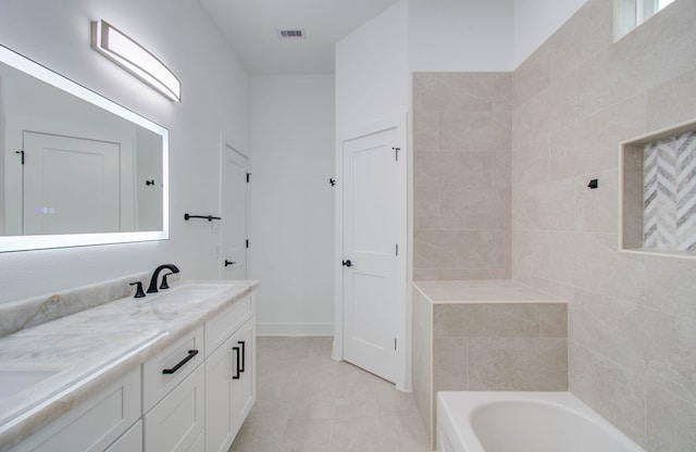 bathroom with vanity, a bathtub, and tile patterned floors