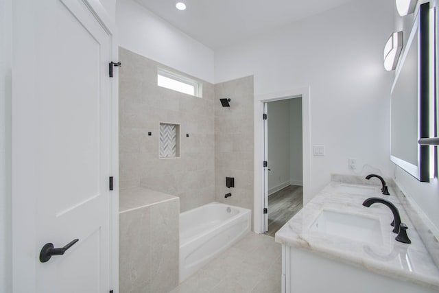 bathroom with vanity, tiled shower / bath, and tile patterned floors