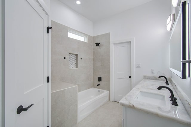 bathroom featuring vanity, tiled shower / bath combo, and tile patterned flooring