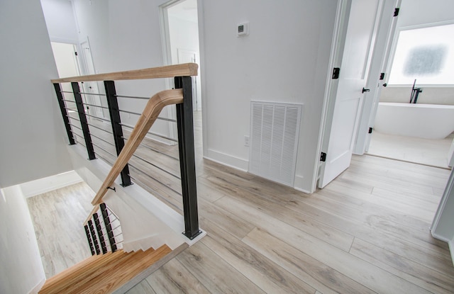 staircase featuring hardwood / wood-style flooring