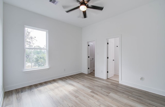 empty room featuring ceiling fan and light wood-type flooring