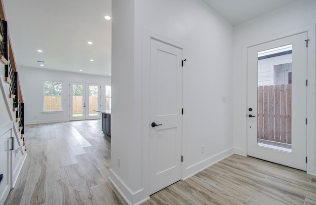 entryway featuring french doors and light hardwood / wood-style floors