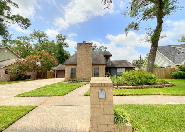 view of front of house featuring a front yard and a garage