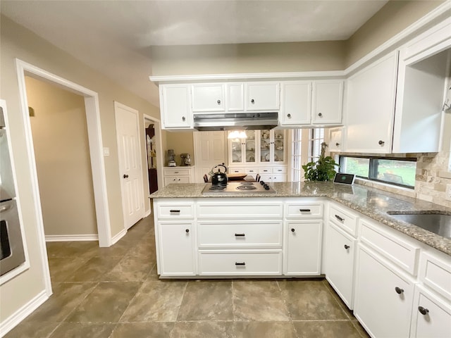 kitchen featuring light stone countertops, white cabinetry, and stainless steel appliances