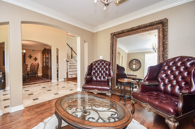 sitting room featuring crown molding and hardwood / wood-style flooring