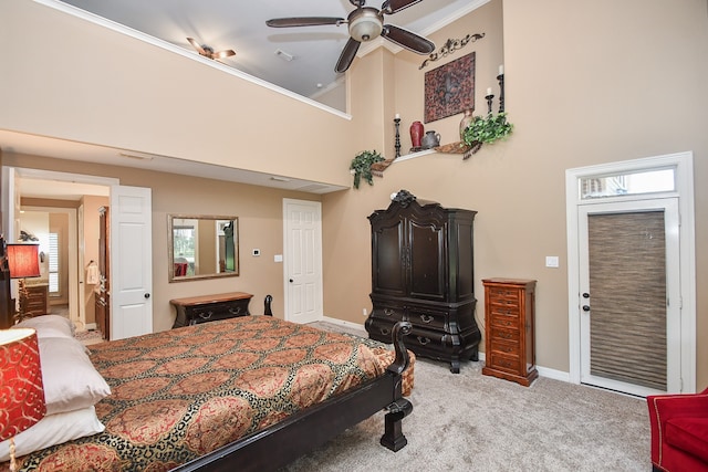 bedroom with a high ceiling, multiple windows, ornamental molding, carpet floors, and ceiling fan