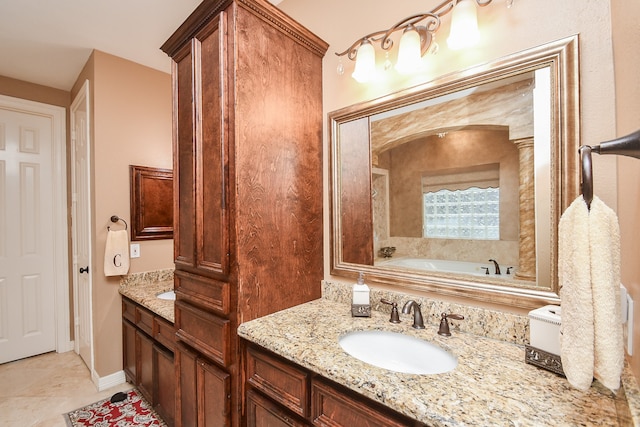 bathroom with vanity, a tub, and tile patterned flooring