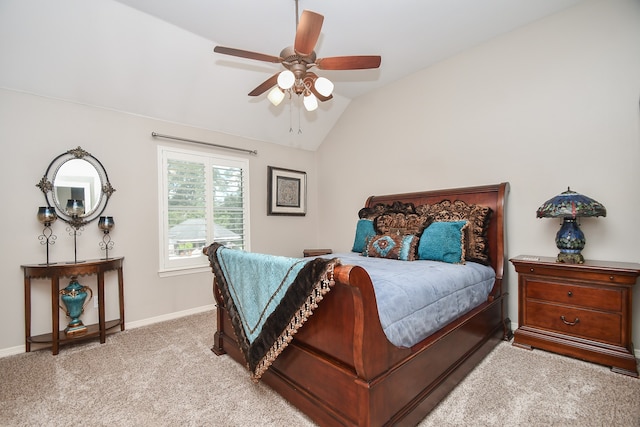 carpeted bedroom with ceiling fan and vaulted ceiling