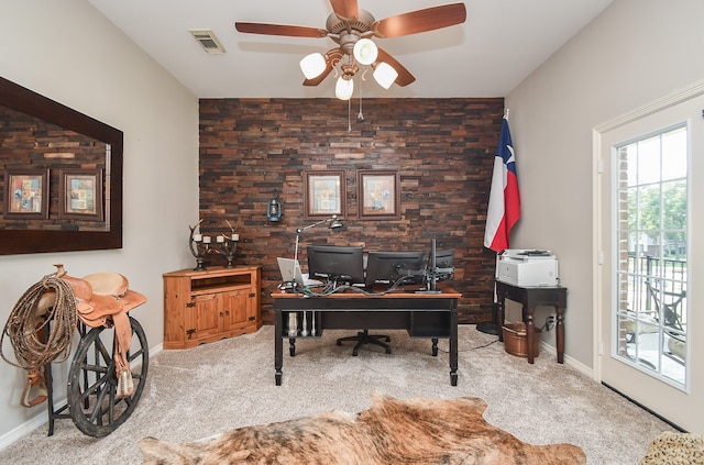 carpeted home office featuring ceiling fan