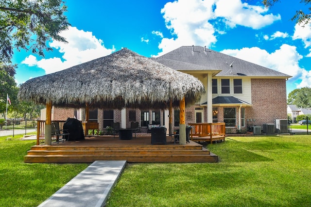 rear view of house featuring central AC, a wooden deck, a yard, and a gazebo