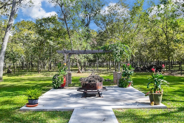 view of property's community featuring a patio area and a lawn