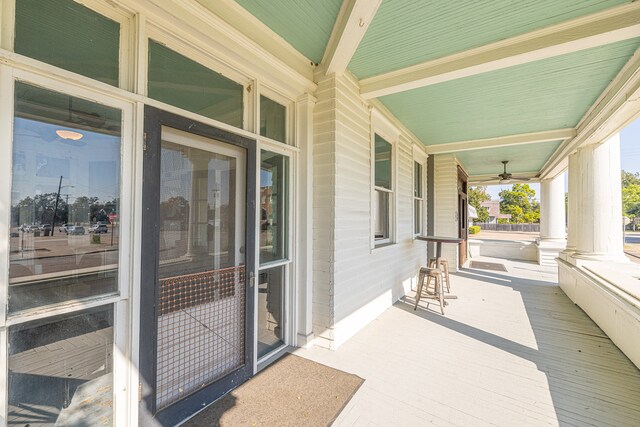 view of patio with ceiling fan and a porch